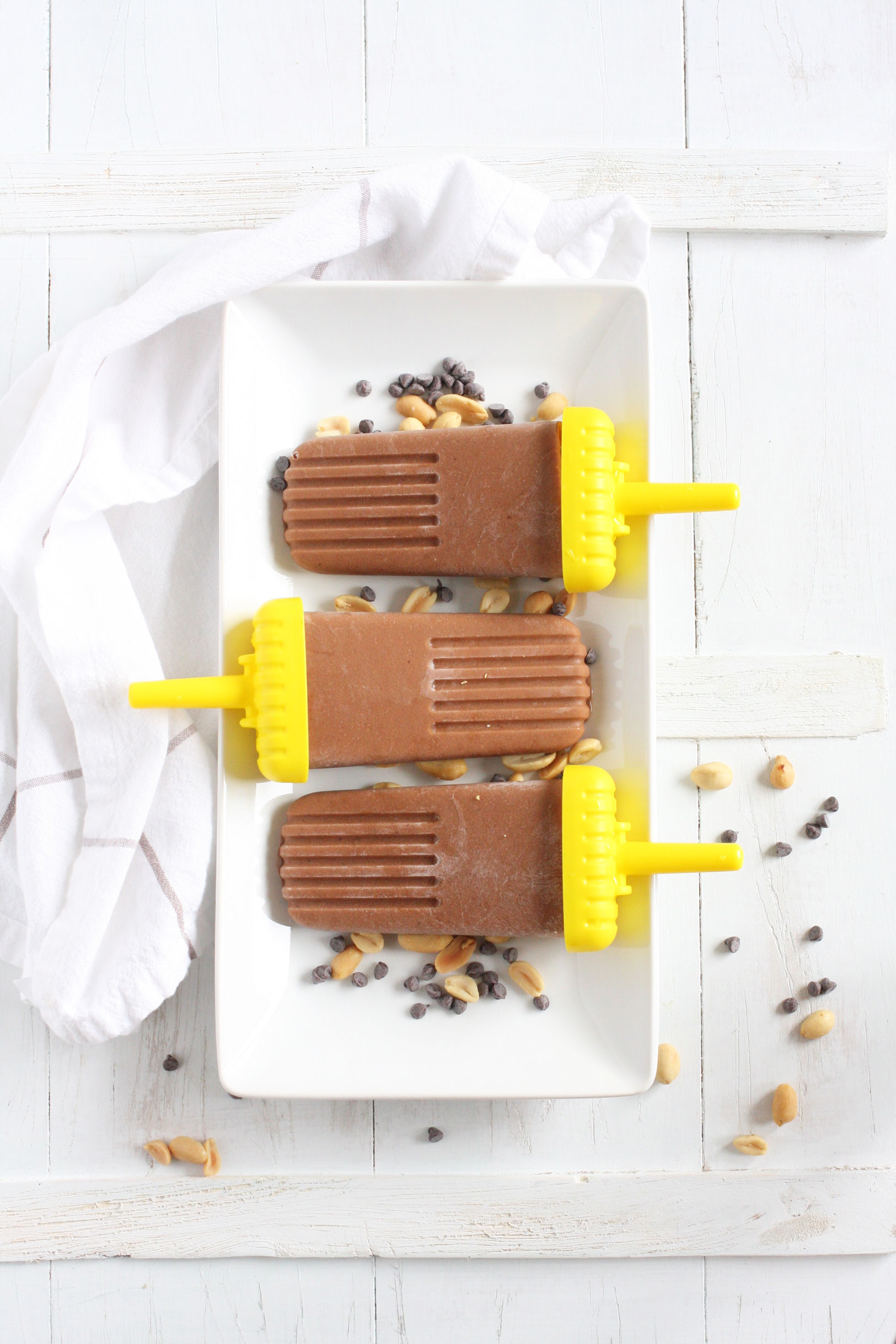 Skinny Chocolate Peanut Butter Popsicles // These popsicles are made with only four ingredients, come in at about 100 calories each, and are a great way to cool down in the summer heat.